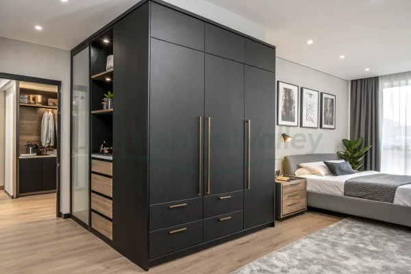 Contemporary bedroom featuring matte black L-shaped wardrobe with overhead cabinets and wood accents