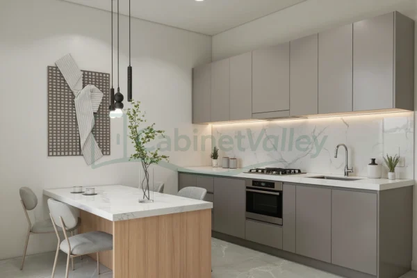 Modern L-shaped kitchen with matte grey cabinets, waterfall-edge table, and soft lighting.