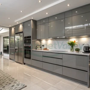 Streamlined grey kitchen design featuring full-height cabinets, built-in oven, and sleek surfaces.