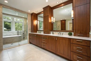 Full view of a contemporary bathroom with walnut veneer cabinetry and dual mirrors