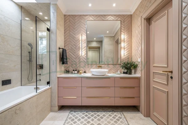 Modern blush floating vanity with gold hardware, marble countertop, and integrated mirror in a neutral-toned bathroom.