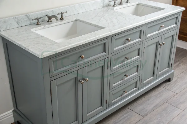 Close-up of gray vanity drawers with chrome knobs and soft-close features below a marble counter