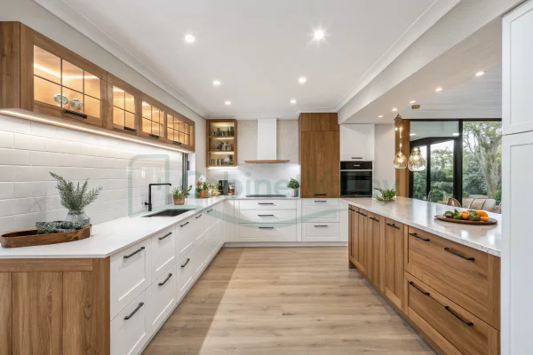 Modern L-shaped kitchen with matte white cabinets, marble countertop, and wood range hood in a traditional-modern fusion style.